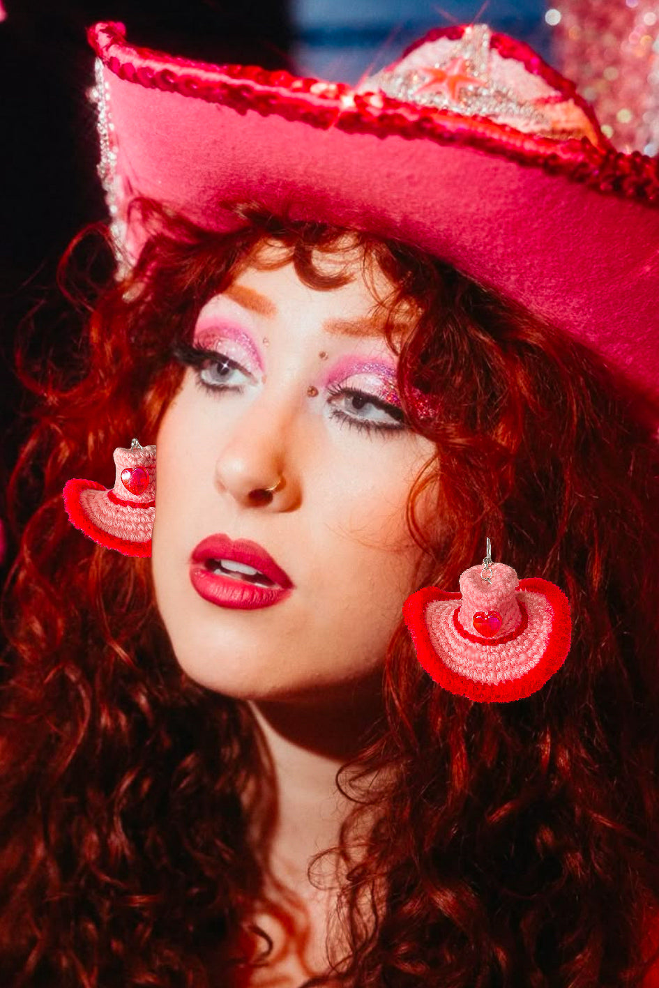 An edit of Chappell Roan wearing our crocheted cowboy hat earrings in pink with red detailing and a cowboy hat on her head that matches.