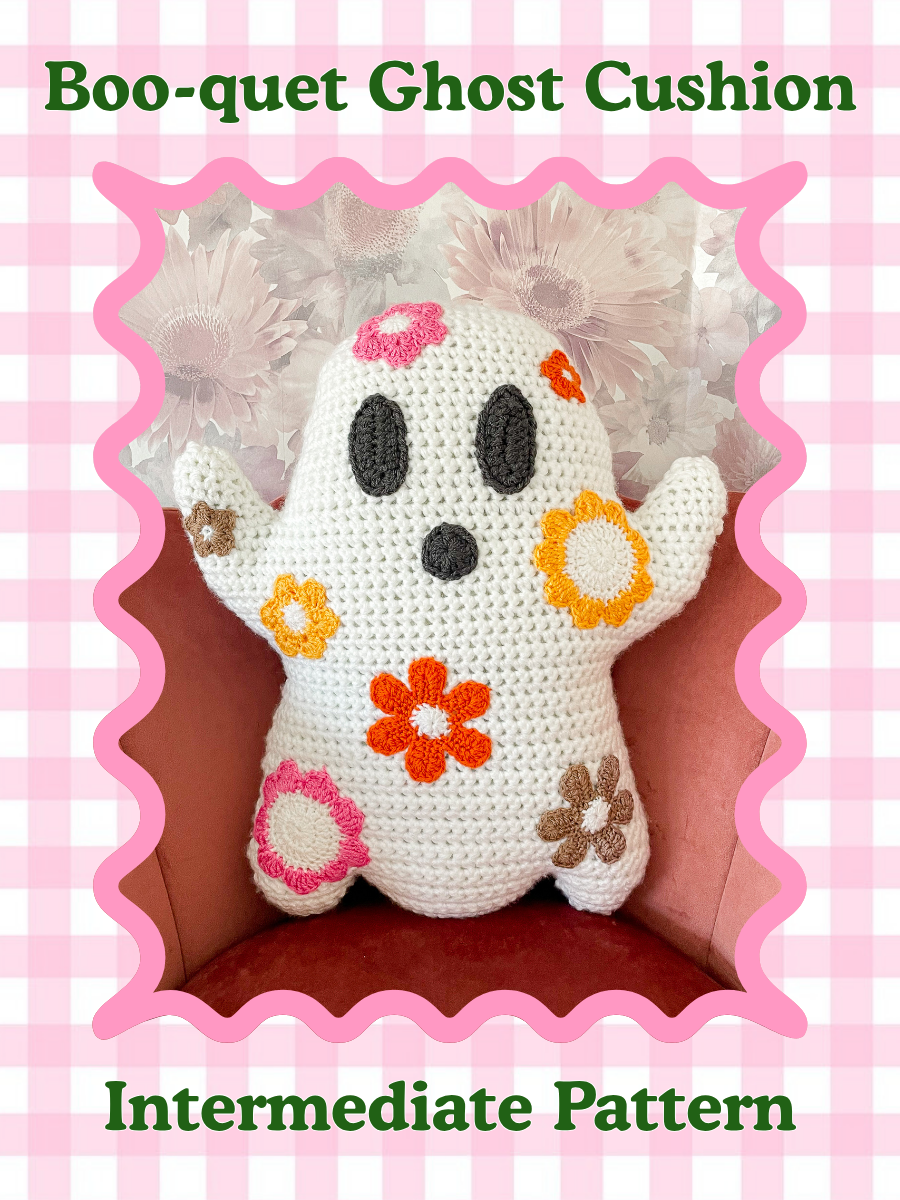 Crochet pattern cover of a ghost shaped pillow with multicoloured flowers sitting on a pink chair with the words 'bouquet ghost pillow' and the skill level 'intermediate' around it.