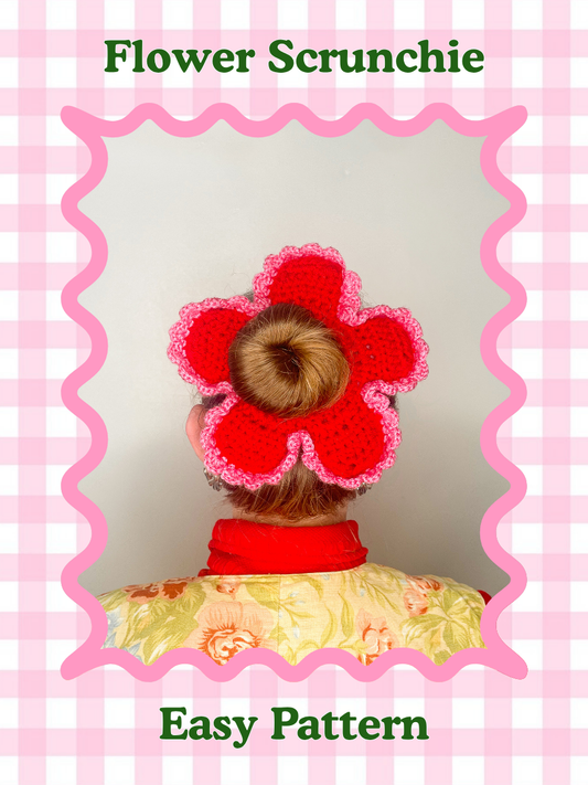A pattern cover of a woman wearing a crochet scrunchie shaped like a flower with the words 'flower scrunchie' and the skill level 'easy' around the image.