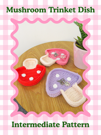 Pattern cover of three crochet mushroom trinket dishes together on a wooden table, with text saying 'intermediate'  for the skill level and the pattern title.