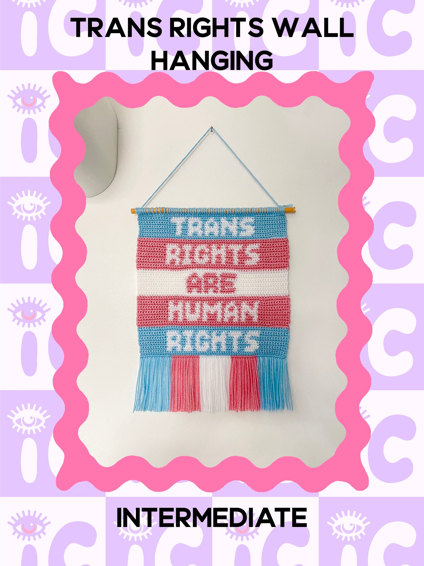 Crochet pattern cover of tapestry artwork with a quote 'trans rights are human rights', hanging on a wall with the words 'trans rights wall hanging' and the skill level 'intermediate' around it.